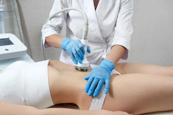 Lost the Weight but Not the Loose Skin? 2 woman having HIFU treatment on her stomach to combat loose skin Bedford following weight loss